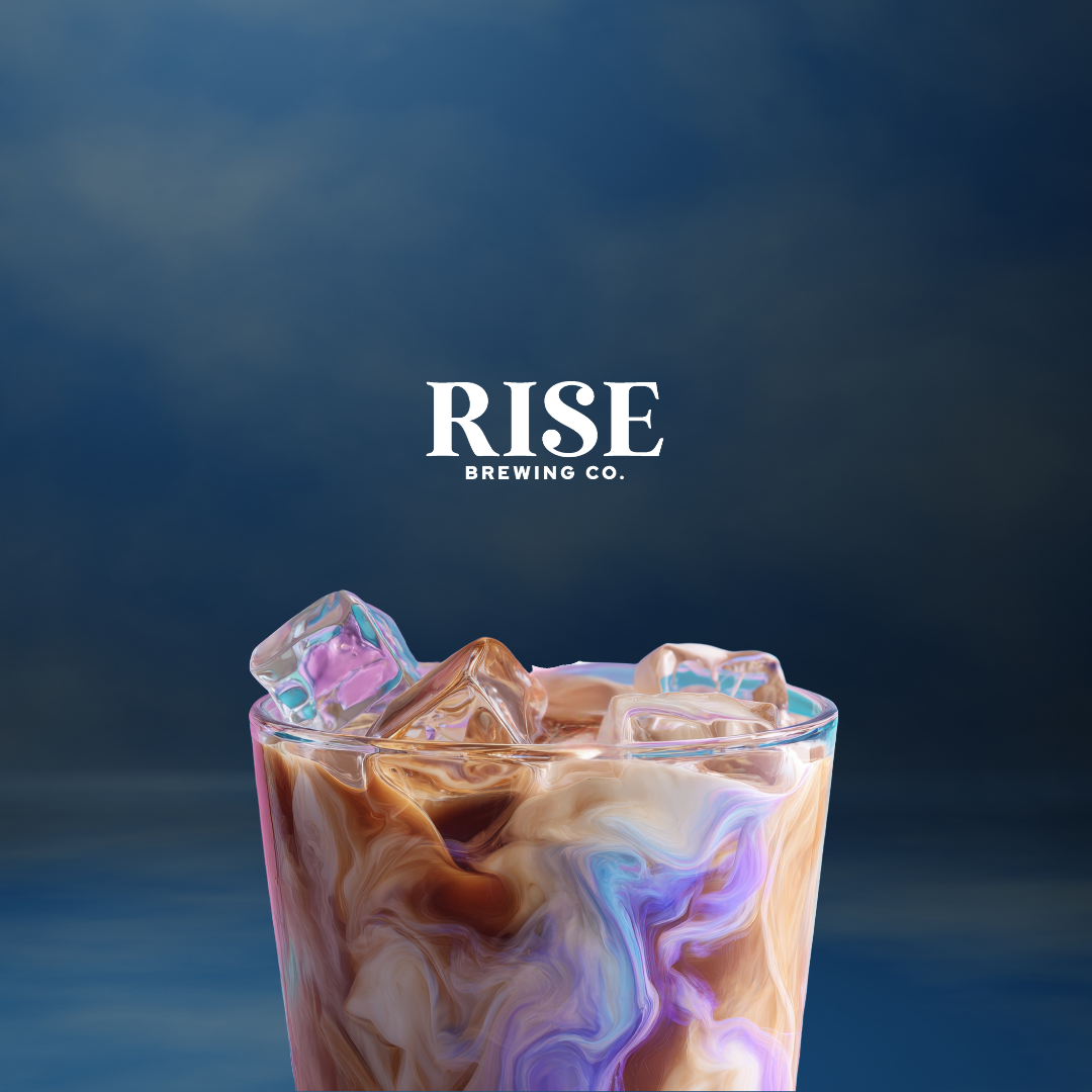 Iced RISE latte with swirling milk on deep blue background